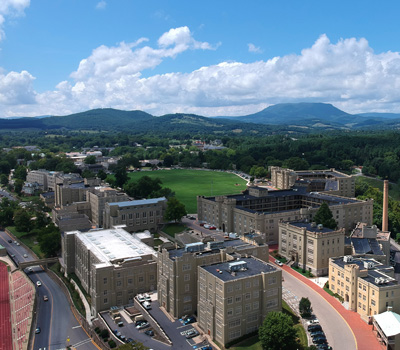 Aerial view of VMI post and buildings with mountains and clouds in background