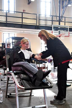 A nurse prepares Lauren Kattmann ’23 for donating blood during the blood drive