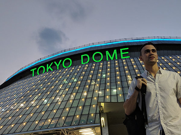 A student stands in front of the Tokyo Dome