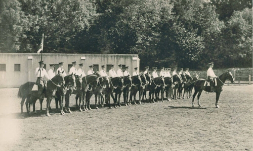 VMI Cavalry Troop A at the VMI stables, late summer or early fall, 1945.  Troop commander Cadet James M. Morgan (Class of 1945) is in front; Charles J. Schaefer (1948B) is third from left.