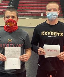 Luke Fegley 24 and Freddy Junko 24 participate in the holiday community outreach project by writing letters to seniors in local facilities. Photo courtesy of Jim Gibson, VMI head wrestling coach.
