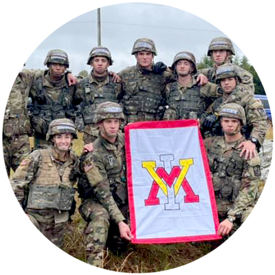 Ranger Challenge cadets in combat uniform holding VMI flag group photo circle
