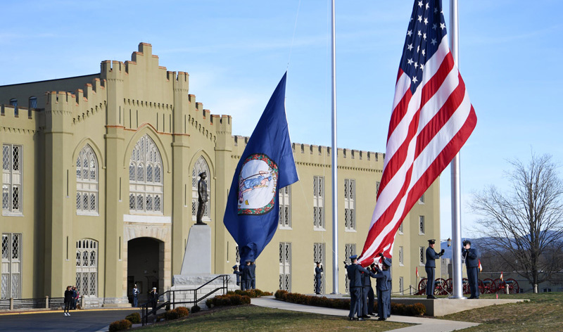VMI cadets raise the Virginia and US flags before a parade