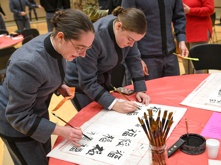 VMI cadets writing Chinese calligraphy during Lunar New Year event