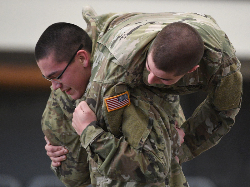 A first year VMI cadet carries another first year cadet on his shoulders during Break Out