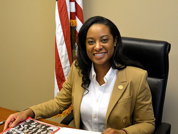 A woman sitting in front of a desk