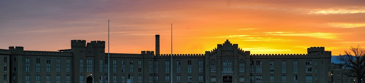 Colorful sky during sunset over barracks.