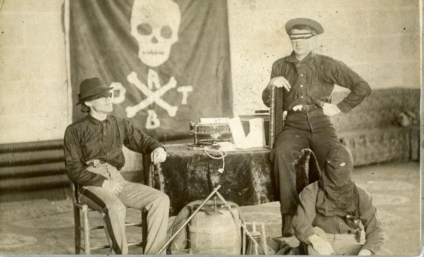 VMI Cadet secret society, the Molly Maguires. Skull and cross-bone banner in background. Includes Frank G. Doggett, Class of 1892; John B. Nicholson, Class of 1893.