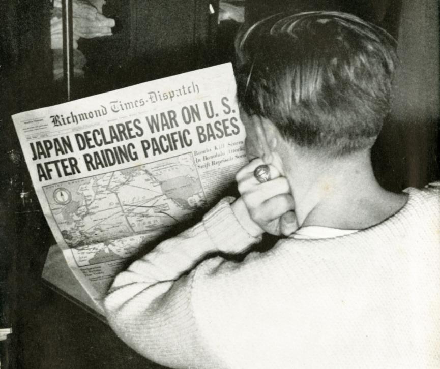 VMI cadet reads the Richmond Times Dispatch front page regarding Japanese declaration of war.