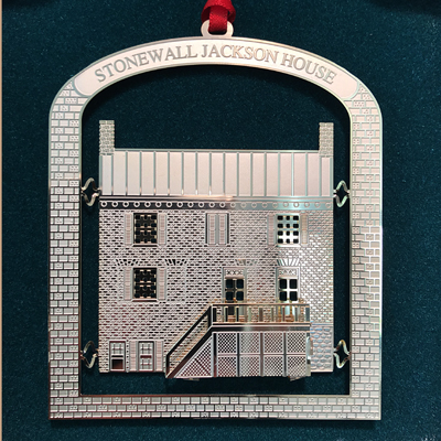 Rounded archway frame with Stonewall Jackson House on the top and a brick pattern inside is a replica of the House with the front staircase dimensionally raised from the house