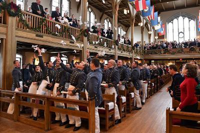 Cadets toss their gloves into the air in Jackson Memorial Hall.