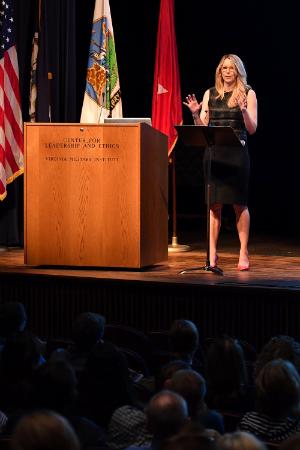 Image of Christine McKinley speaking on Gillis Theater stage