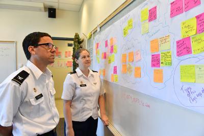 Col. Troy Siemers and Maj. Jessica Libertini brainstorm ideas for the new math curriculum while looking at suggestions from other academic departments. – VMI Photo by Kelly Nye. 
