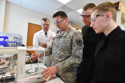 Justin Rose ’17, Devon Kirk ’17, and David LaFuze ’18 work with Col. Stan Smith in the lab. – VMI Photo by H. Lockwood McLaughlin.
