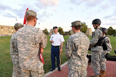 Col. Tom Timmes ’92 speaks with cadets just before firing the evening gun in his role as Officer in Charge.