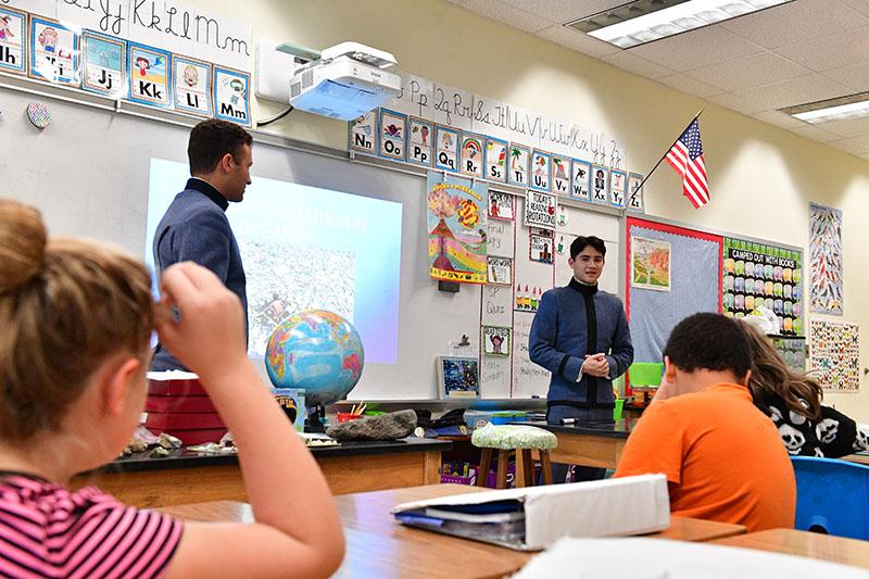 Brandon Campbell '20 and Christian Vaccaro '19 talk to 5th graders about ocean plastic.