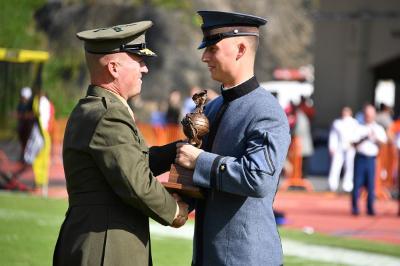 Alex Dragan '20 accepts the Marine Corps Commandant's Trophy from Maj. Gen. James