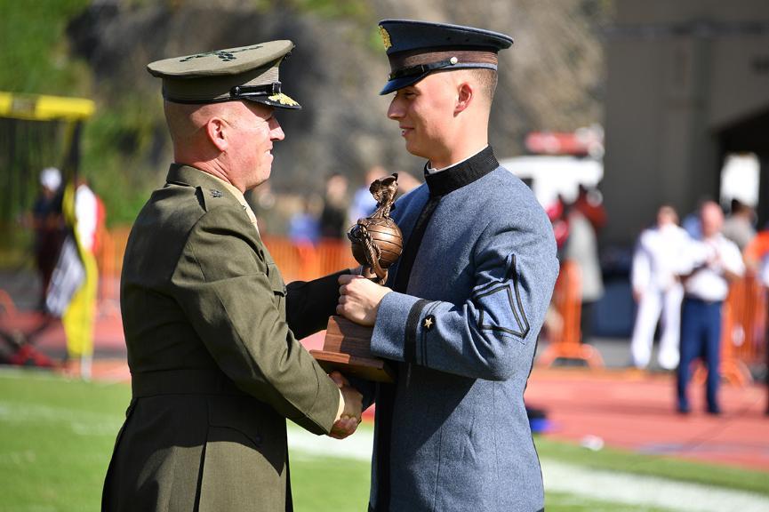 Alex Dragan '20 accepts the Marine Corps Commandant's Trophy from Maj. Gen.  James 