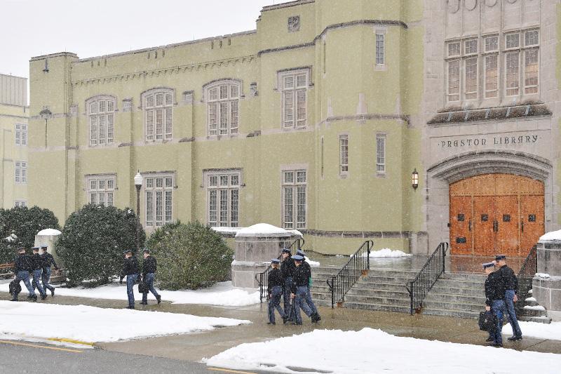 Cadets walk through the snow to class.