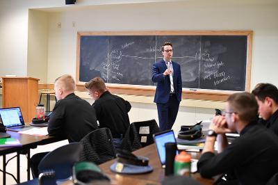 Dr. Timothy Passmore stands in front of a class of cadets.