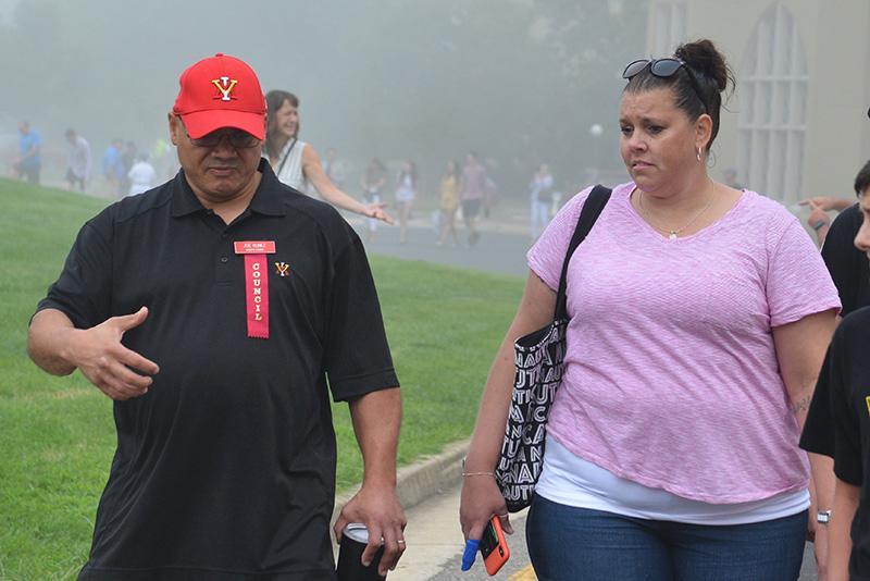 A Parents Council member walks and talks with the family member of an incoming cadet.