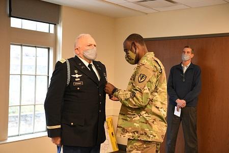 Maj. Gen. Cedric T. Wins, interim superintendent, pins a VMI Meritorious Service Medal on Eric Hutchings, recognizing his service to the Institute upon his retirement. - VMI Photo by Kelly Nye. 