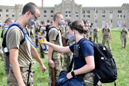 Savanah Diamond ’22, one of VMI’s many cadet EMTs, applies sunscreen to a rat during Matriculation Week.—VMI Photo by Mary Price.