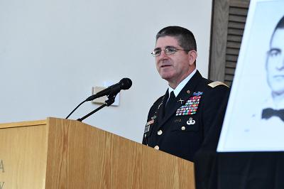 Col. Wanovich standing at podium, speaking
