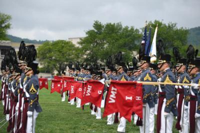 VMI cadets march with red VMI flags on parade ground for Memorial Parade 2022