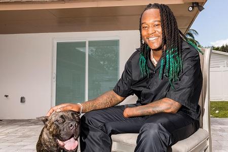 Shaquem Griffin poses with dog.
