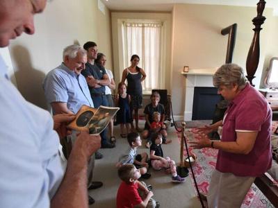 Children listen to a docent during a tour. 